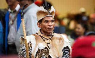 A man in traditional Khoi San regalia waits before a land expropriation hearing being held in a church in Cape Town - Friday 4 August 2018