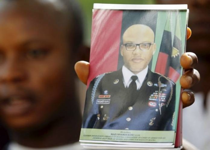 A supporter of Indigenous People of Biafra (IPOB) leader Nnamdi Kanu holds a photograph of Kanu, who is expected to appear at a magistrate court, during a rally in Abuja, Nigeria December 1, 2015. Kanu - an activist who divides his time between the UK and Nigeria, spreading his ethos on social media and Radio Biafra - was arrested on charges of criminal conspiracy and belonging to an illegal society. REUTERS/Afolabi Sotunde