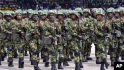 Nigerian soldiers march during 58th anniversary celebrations of Nigerian independence, in Abuja, Nigeria, Monday, Oct. 1, 2018. (AP Photo/Olamikan Gbemiga)